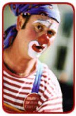 A clown wearing a striped shirt and a purple headband
