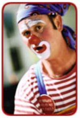 A man dressed as a clown with a medal around his neck