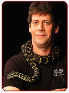 A man with a snake wrapped around his neck