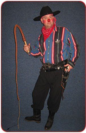 A man dressed as a cowboy is holding a whip