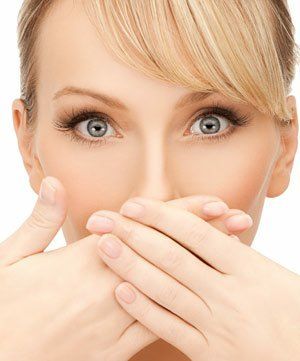 woman covering mouth