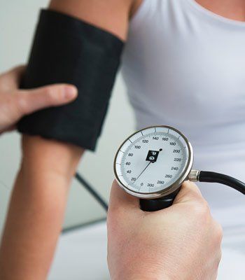 woman getting blood pressure checked