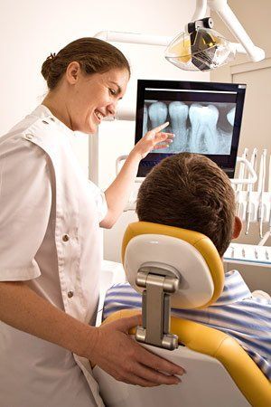 dentist showing patient xrays