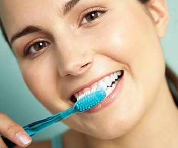 young woman brushing teeth