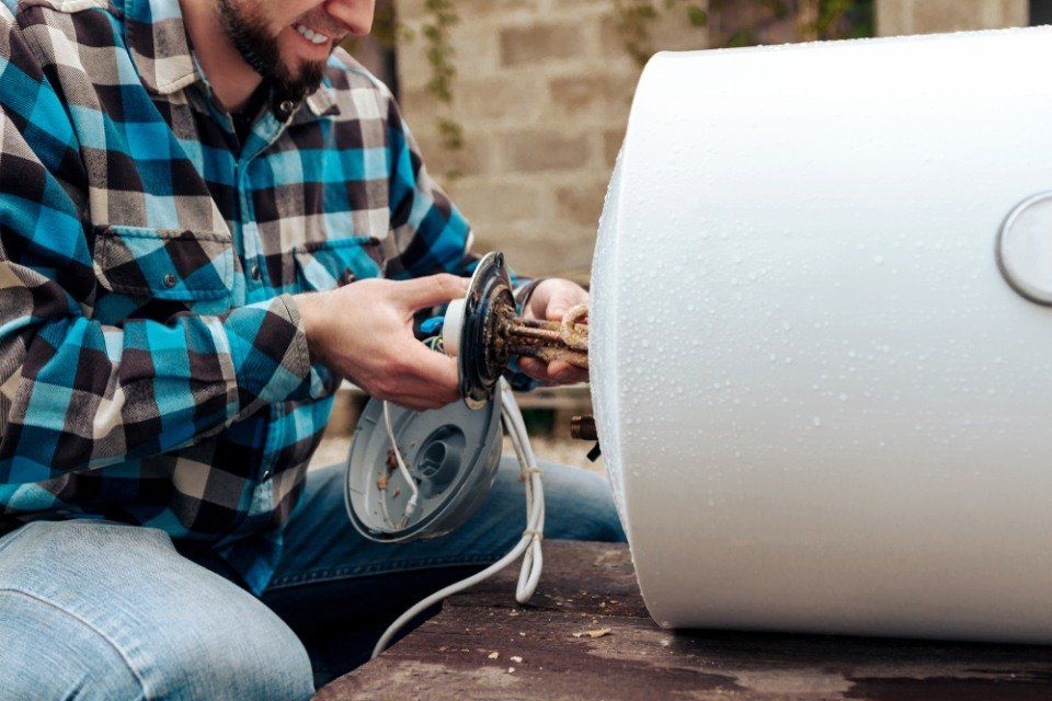 An expert replacing a boiler