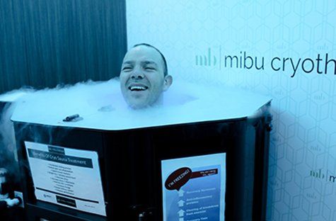 A man is sitting in a box filled with liquid nitrogen.
