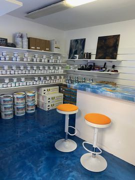 Two bar stools are sitting in front of a counter in a store.