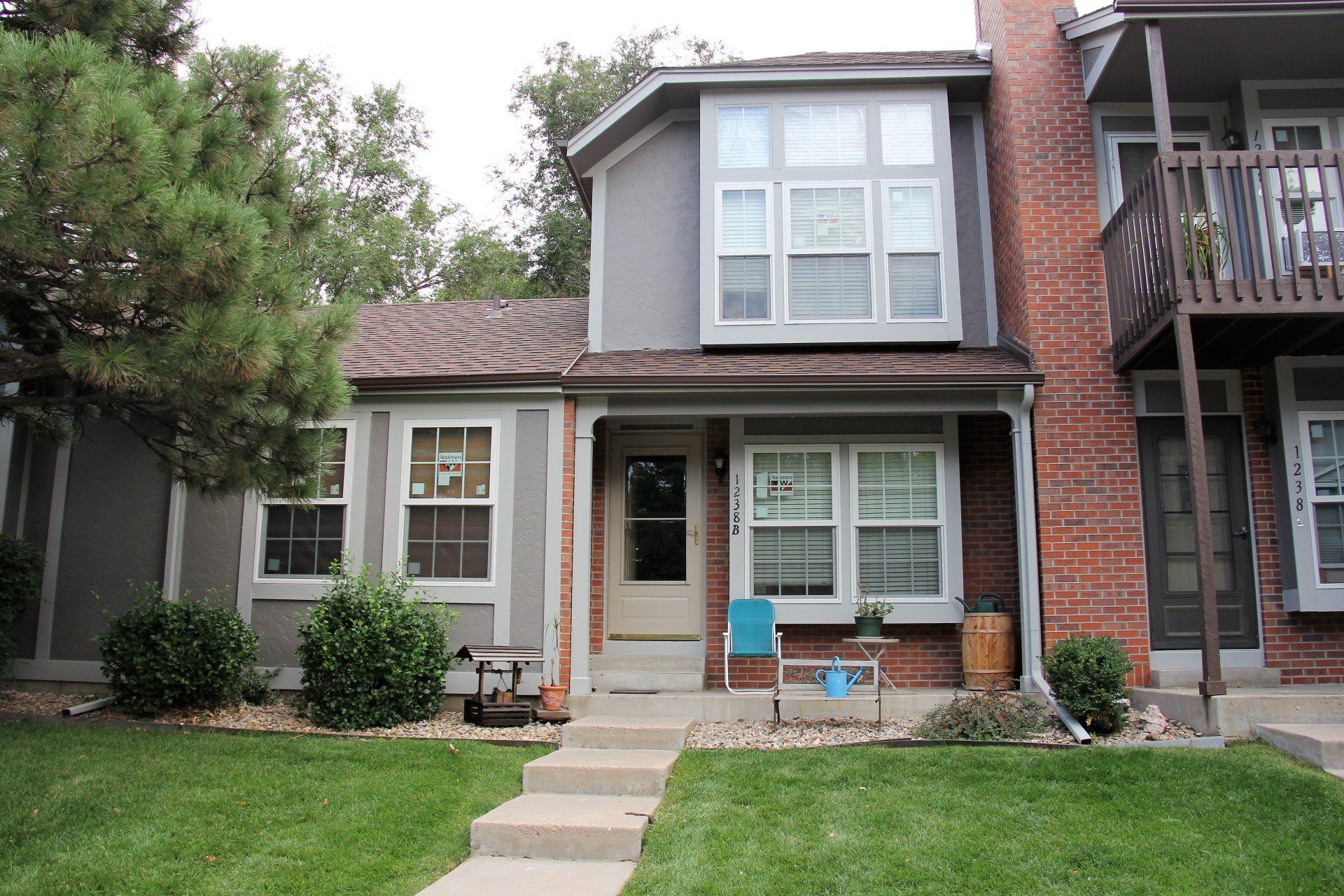 Multiple residences of a two-story complex have windows that were recently installed.