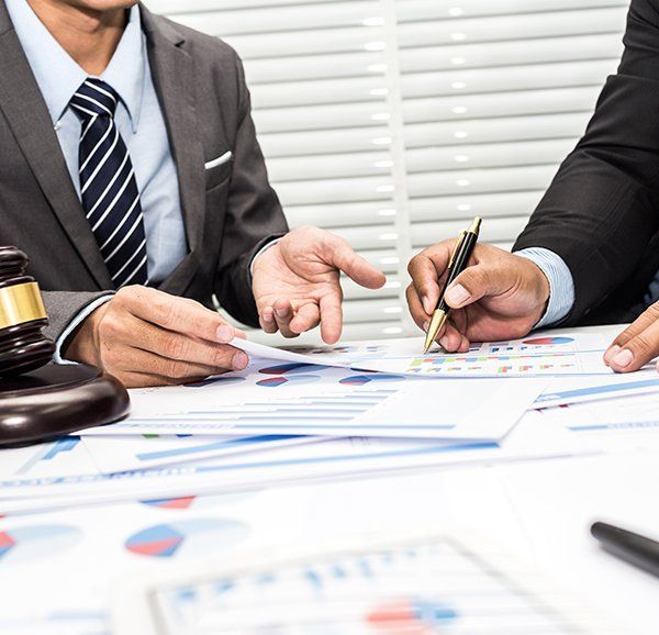 Lawyers Discussing Financial Reports — Lawyers in Dubbo, NSW Lawyers Discussing Financial Reports — Lawyers in Dubbo, NSW