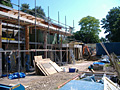 A house is being built on a construction site with scaffolding.