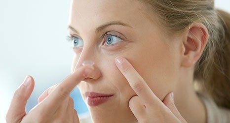 a girl using contact lenses