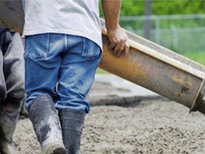 Worker Pouring Concrete on Road — Mercedes, TX — Bernal Paving Worker Pouring Concrete on Road — Mercedes, TX — Bernal Paving