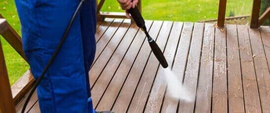 Cleaning Wooden Terrace with High Pressure Washer — Pressure Washer Services in New Galilee, PA Cleaning Wooden Terrace with High Pressure Washer — Pressure Washer Services in New Galilee, PA
