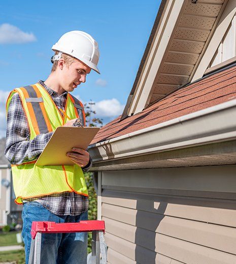 Worker Inspecting House Roof — Louisville, KY — Quality Exteriors Group, LLC Worker Inspecting House Roof — Louisville, KY — Quality Exteriors Group, LLC