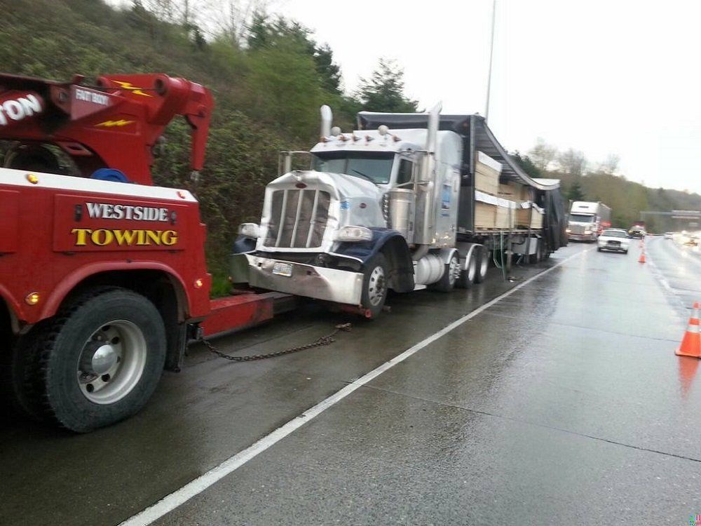 Red Truck Towing a Big Truck — Seattle, WA — Gary's Westside Towing