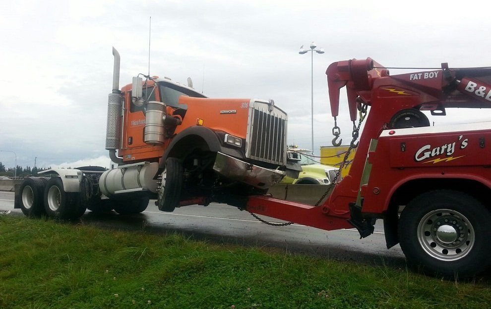 Lifting Orange Truck — Seattle, WA — Gary's Westside Towing