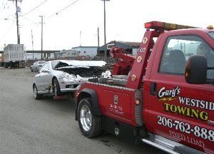 Truck Towing Broken Car — Seattle, WA — Gary's Westside Towingon the Truck — Seattle, WA — Gary's Westside Towing