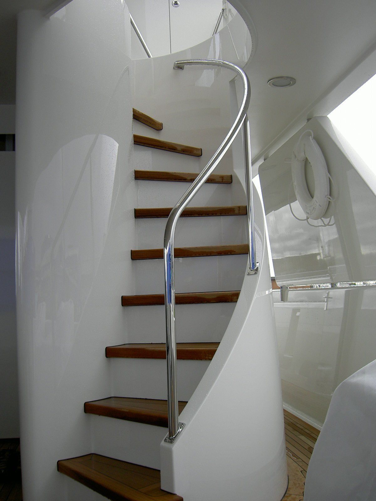 Stainless steel spiral staircase by Tanner Manufacturing installed on a boat.