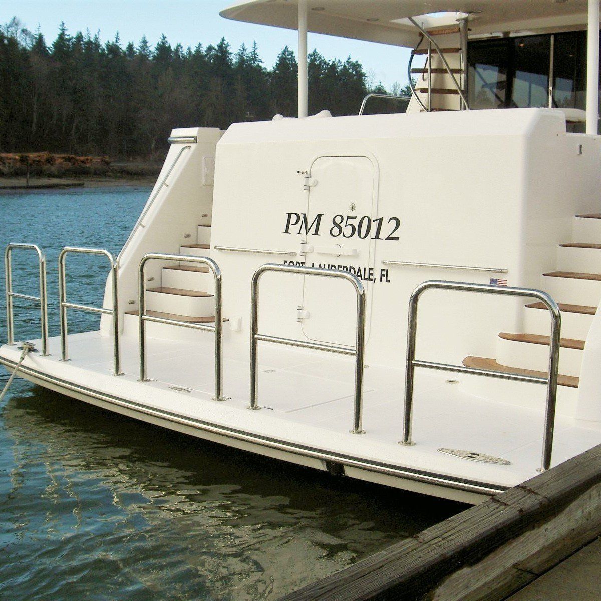 A boat with five staple rails with crossmembers installed on the swim platform of a boat.
