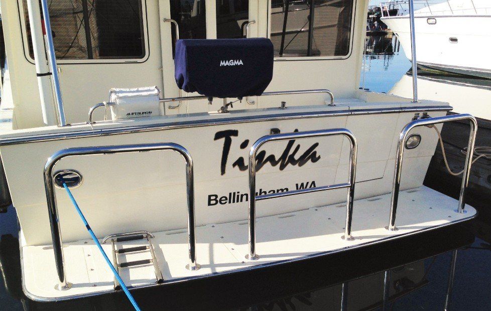 A boat with three staple rails installed on the swim platform. 