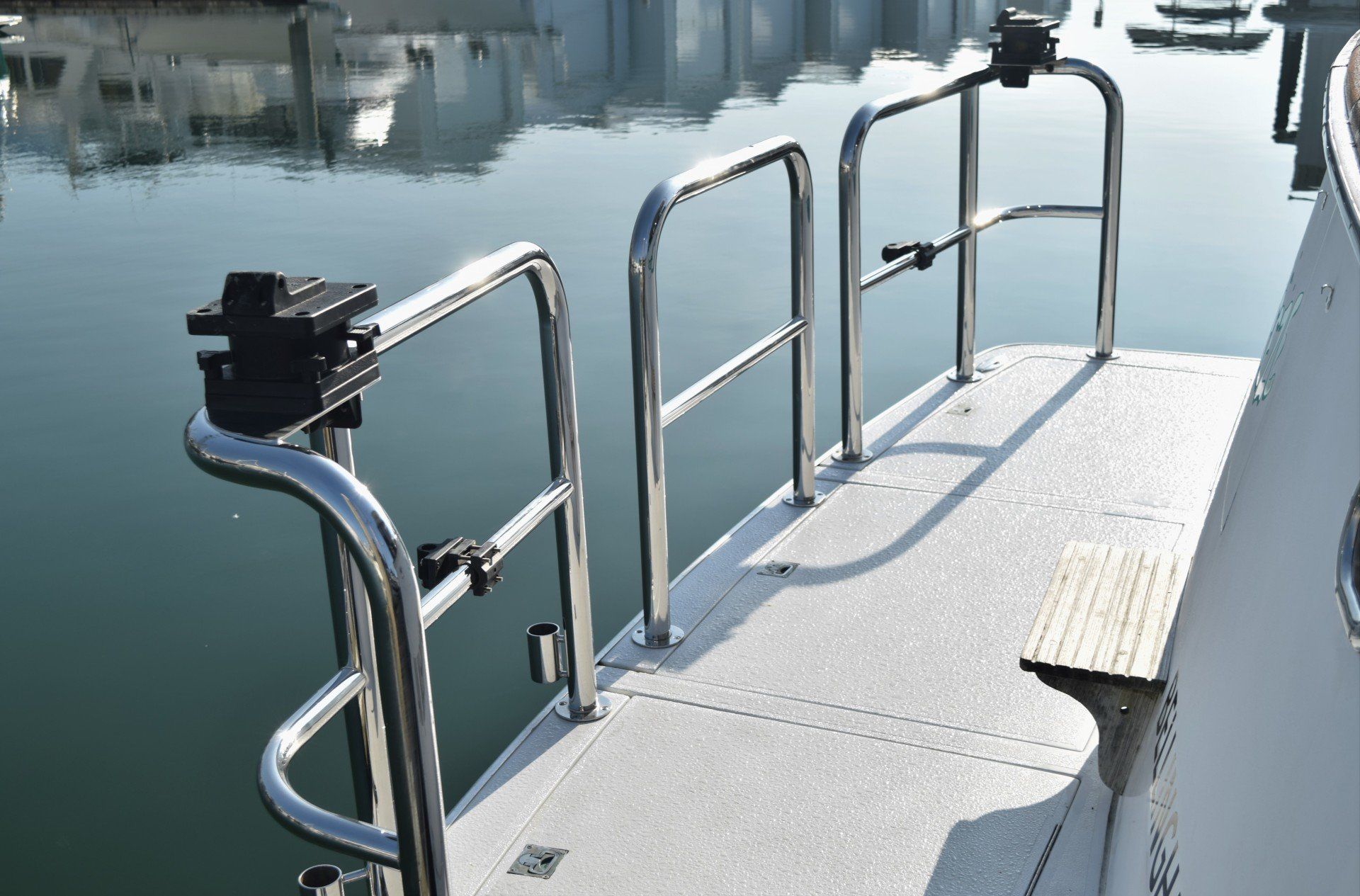 A swim platform with custom corner staple rails by Tanner Manufacturing fixed with downriggers.