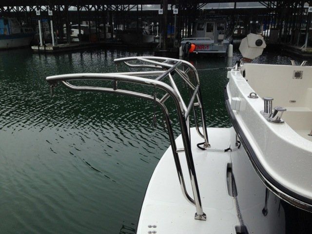 Stainless steel davit system by Tanner Manufacturing installed on a swim platform. 
