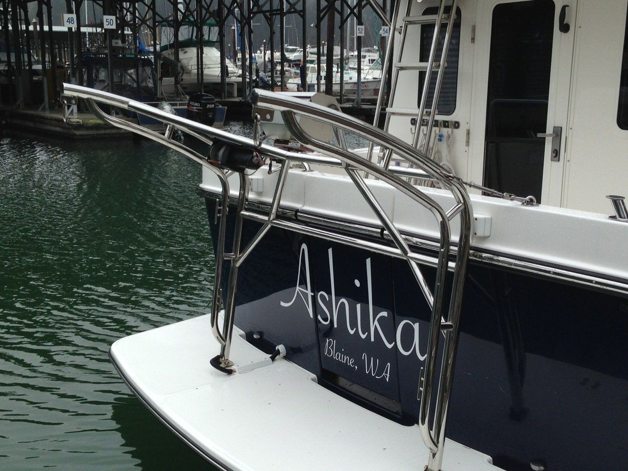 Stainless steel davit system by Tanner Manufacturing installed on a swim platform.
