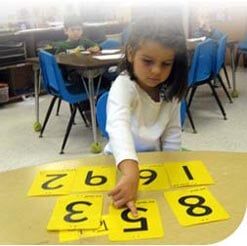 Kid Arranging Numbers — Potomac, MD — Little Acorns Early Learning Center