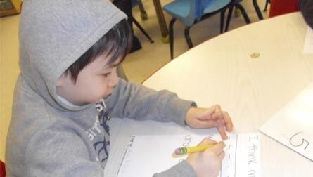 Kid Playing Small Statue Animals — Potomac, MD — Little Acorns Early Learning Center