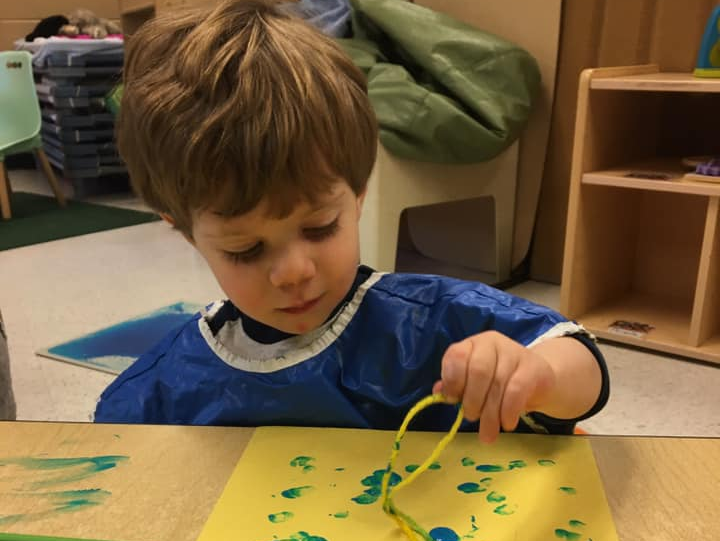 Kid Playing Small Statue Animals — Potomac, MD — Little Acorns Early Learning Center