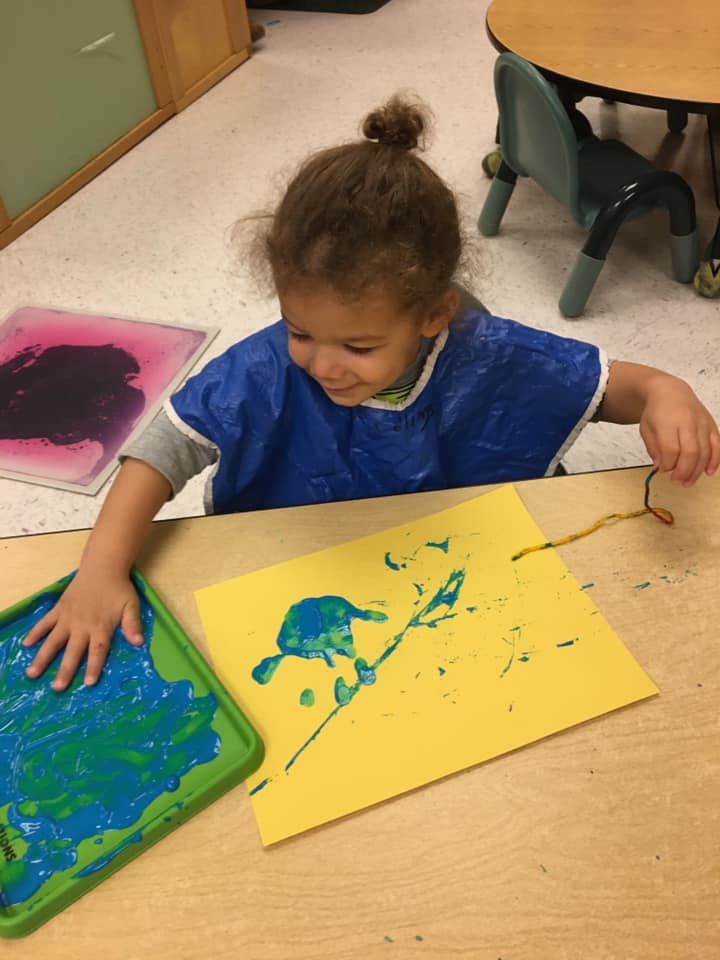 Kid Playing Small Statue Animals — Potomac, MD — Little Acorns Early Learning Center