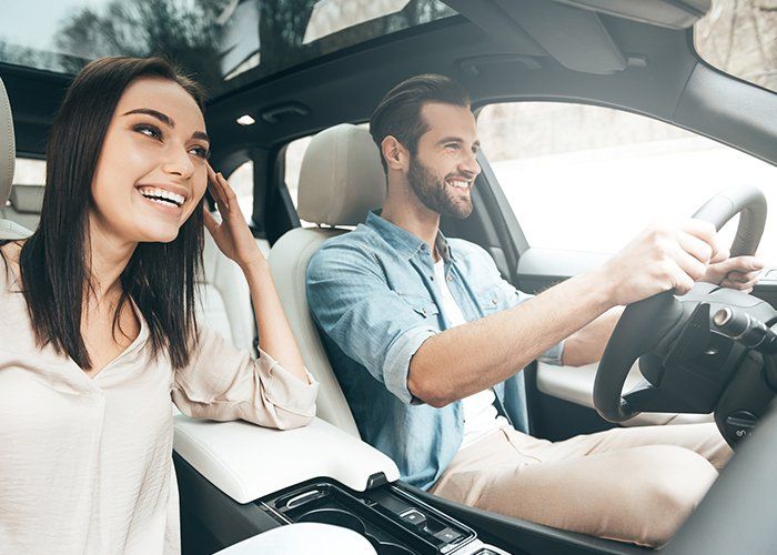Auto Accessories — Happy Couple Enjoying White Man Driving A Car In Chicago, IL