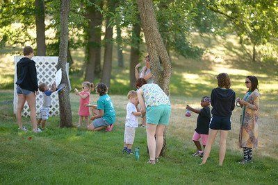 A group of people are playing a game in a park.