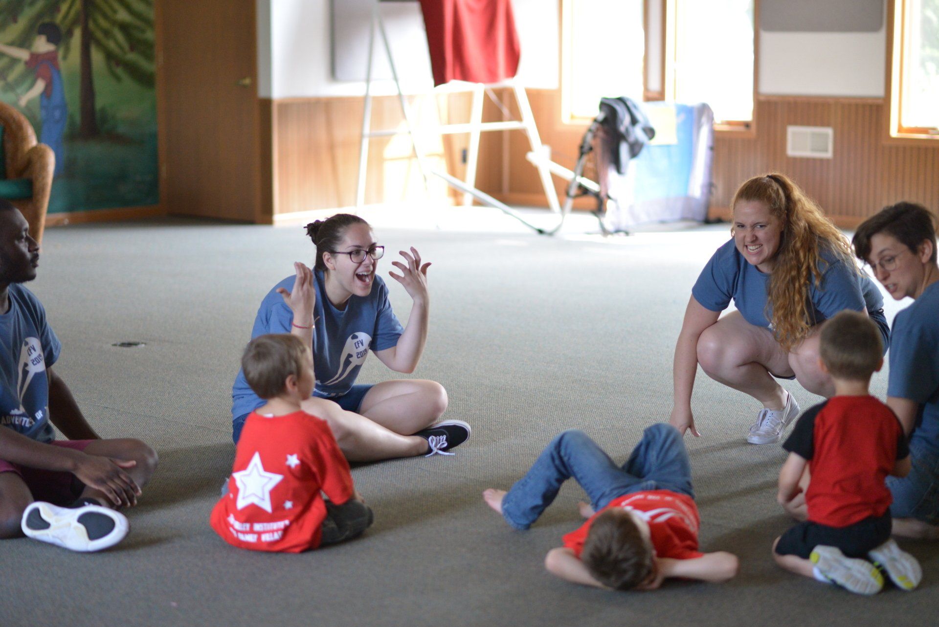 A group of children are sitting in a circle on the floor