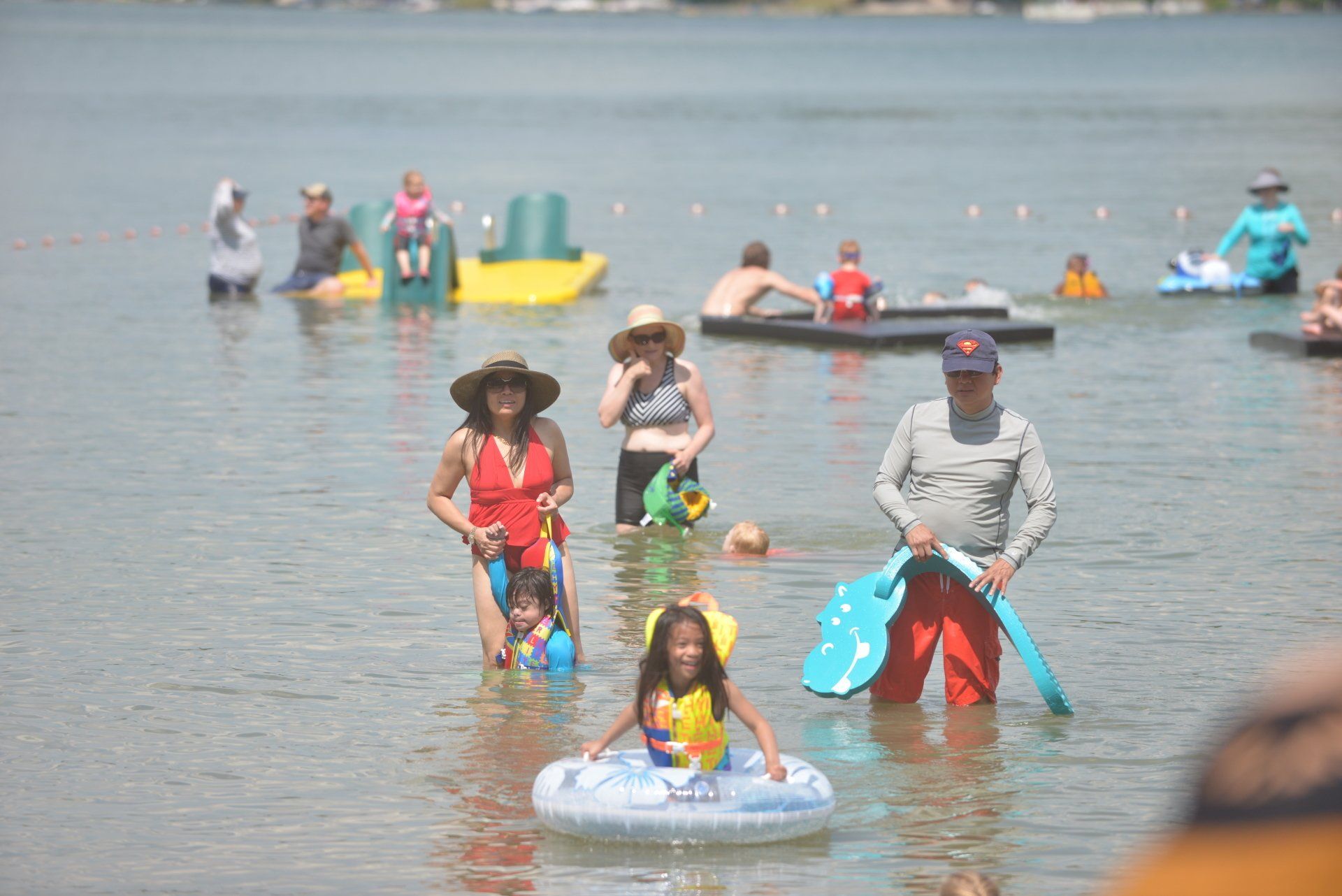 A group of people are swimming in a lake.