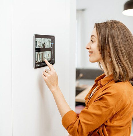 Woman Setting House Security — Valley Cottage, NY — Inter County Alarm Systems