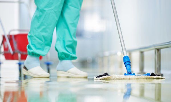Mopping Hospital Hallway — Anderson, SC — CFL Facilities Services A worker doing janitorial services in Greenville, SC