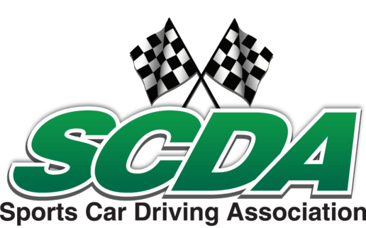 The green logo for the Sports Car Driving Association, featuring two crossed checkered racing flags above the text 