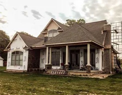 Exterior of home in process of having siding installed
