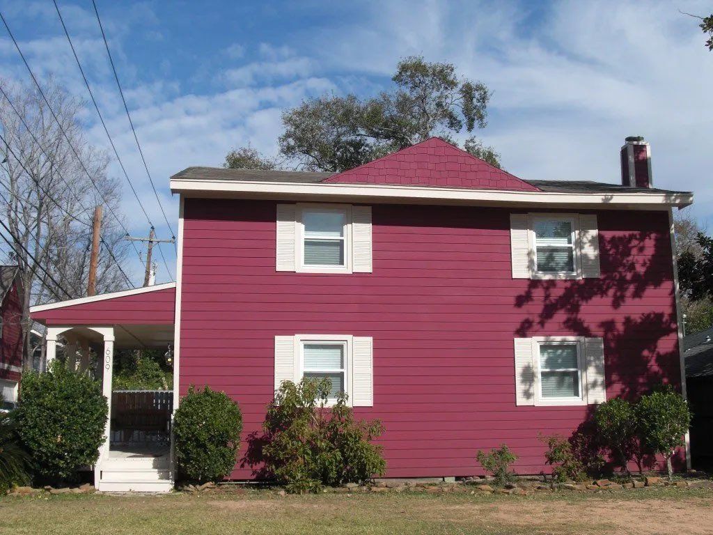 The white shutters and windows trimmed in white against the Hardie siding ties the exterior home together.