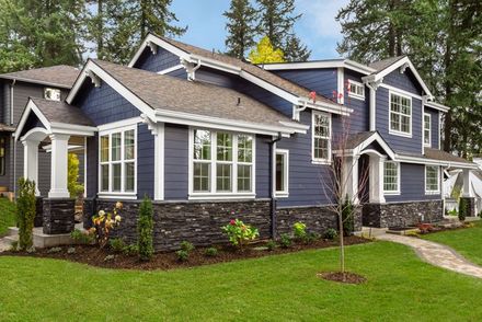 Front View of blue house with siding in the suburbs