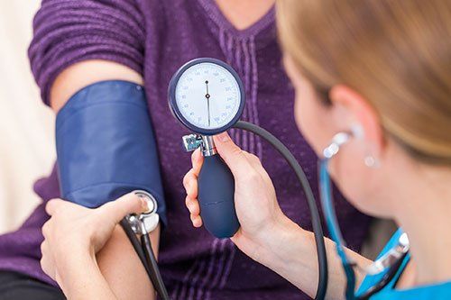 nurse taking patient's blood pressure