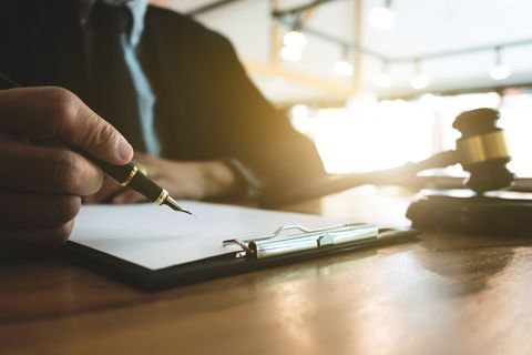 Person Writing Documents — Houma, LA — R. L. Landreneau, Jr. Attorney At Law Person Writing Documents — Houma, LA — R. L. Landreneau, Jr. Attorney At Law