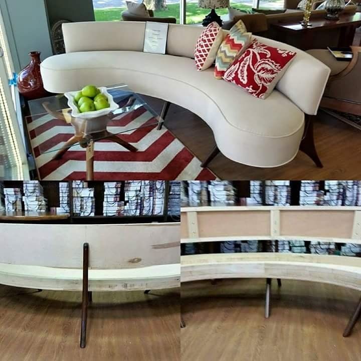 A curved couch with a bowl of apples on it