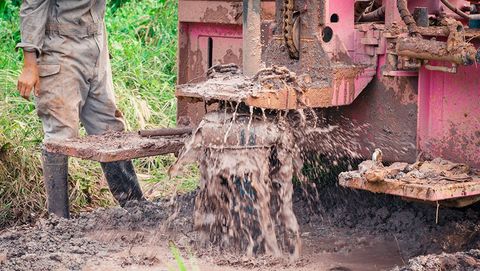Worker Using Well Drilling Truck — Aylett, VA — Helmick Well & Pump Services, Inc Worker Using Well Drilling Truck — Aylett, VA — Helmick Well & Pump Services, Inc