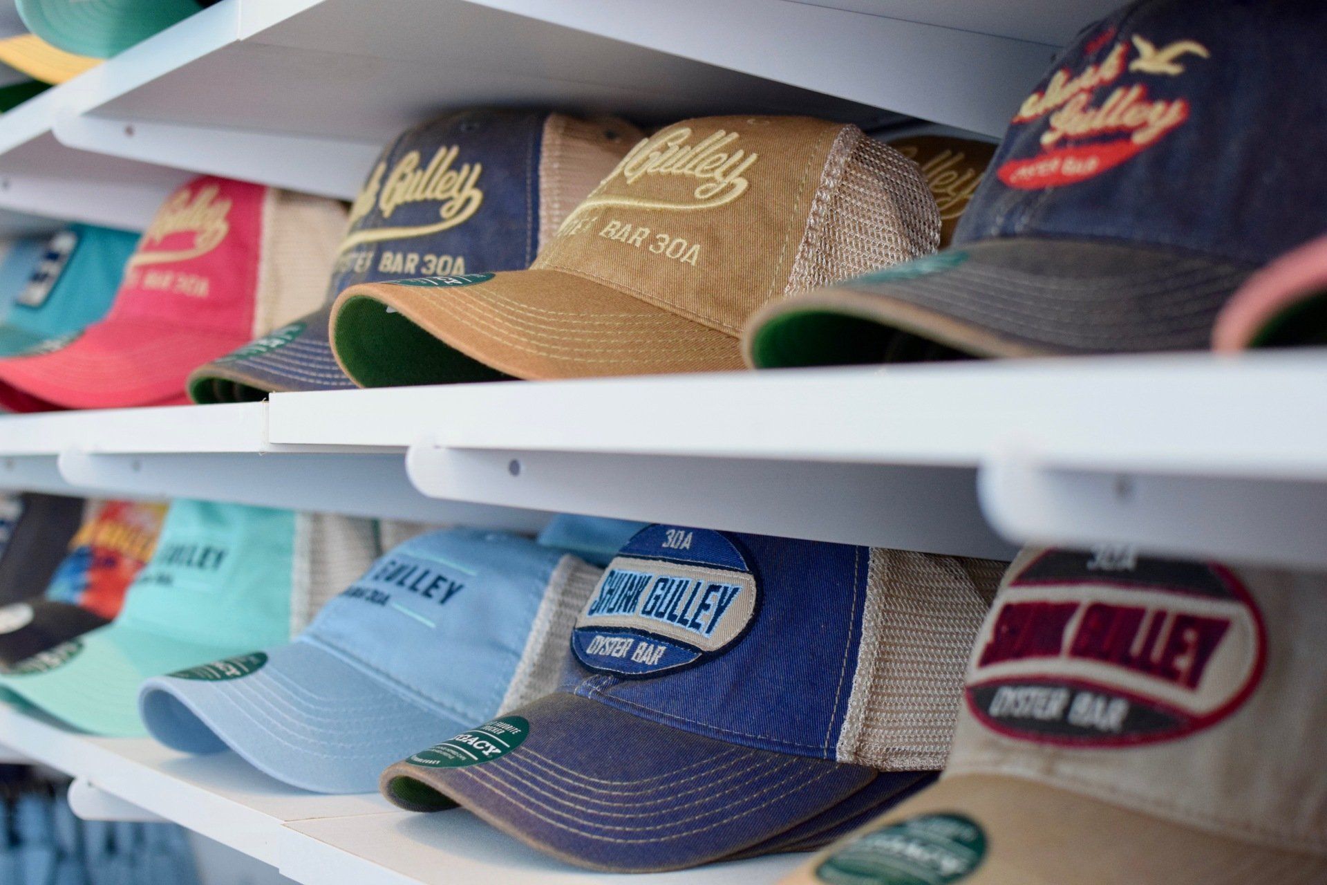 Shelves of colorful embroidered baseball caps in a store display