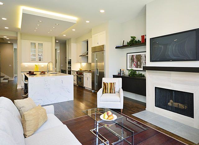 Living room with wood floors, recessed lighting and modern furniture