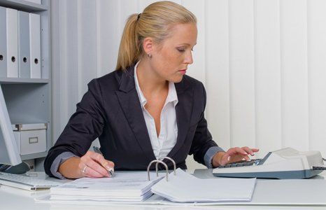 an accountant at work in the office with calculator