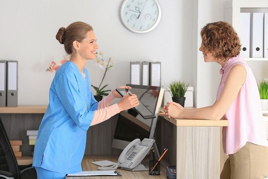 woman showing the information on the tablet to the customer