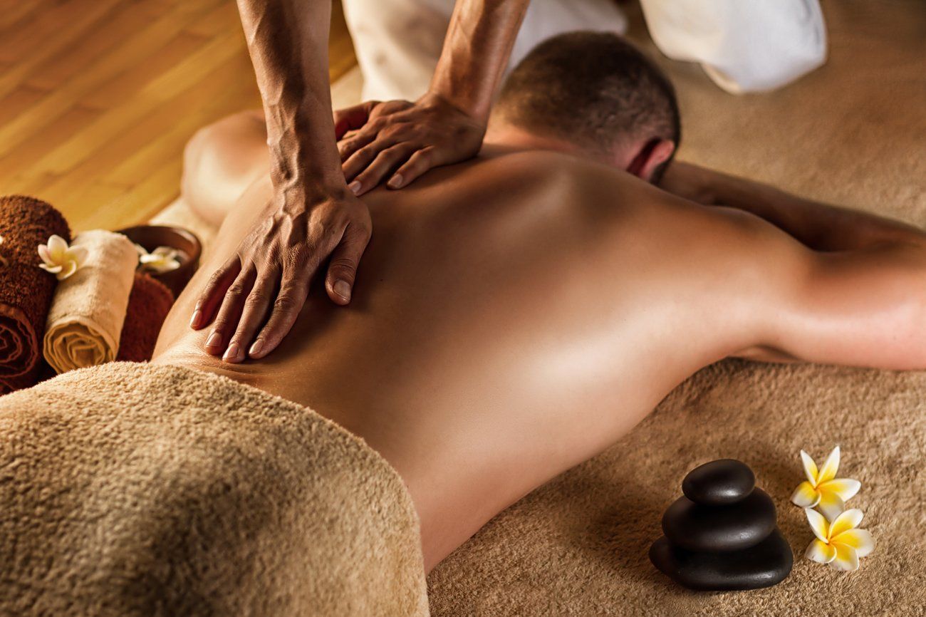 Man Getting Deep Tissue Massage On His Back — Charleston, SC — East Cooper Mobile Massage Man Getting Deep Tissue Massage On His Back — Charleston, SC — East Cooper Mobile Massage